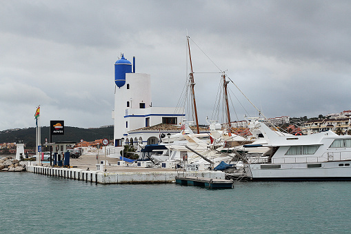 La Linea de la Conception, Spain - February 11, 2016: Colour photograph of Light house and Boats at a Marina in La Linea De Conception oposite Gibraltar.