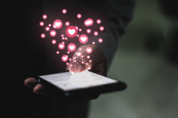 istock Young man using smartphone, social networking, heart icon 1223257320