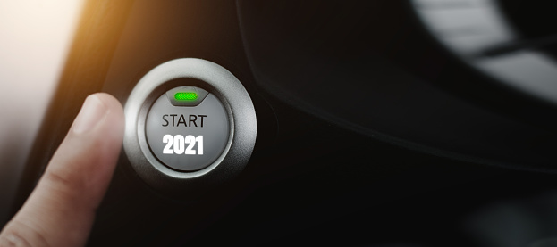 Fingers are poking at the icon button to start the new year, the idea of starting the new year 2021