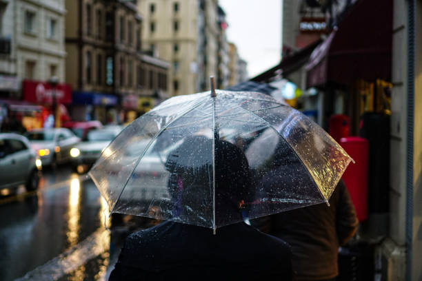 istock People walking with umbrellas in the rain. 1223257891