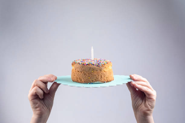 istock Hands holding a vanilla cake in white background 1223258654