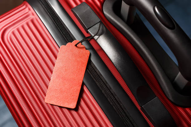 istock Stylish red suitcase with empty travel Insurance label on handle. 1223258666