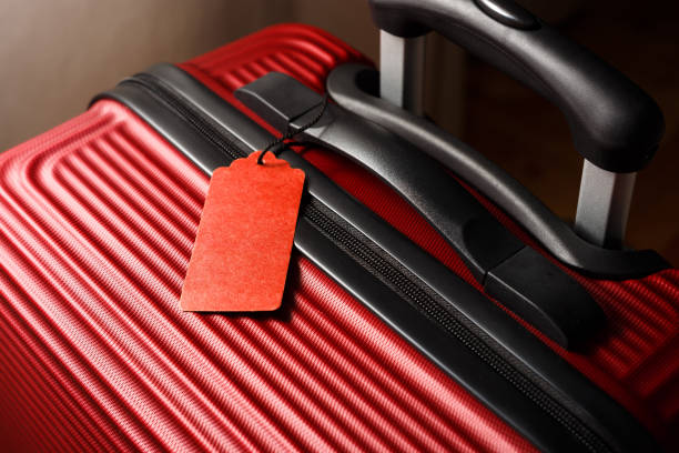 istock Empty travel luggage label on stylish red suitcase. 1223258732
