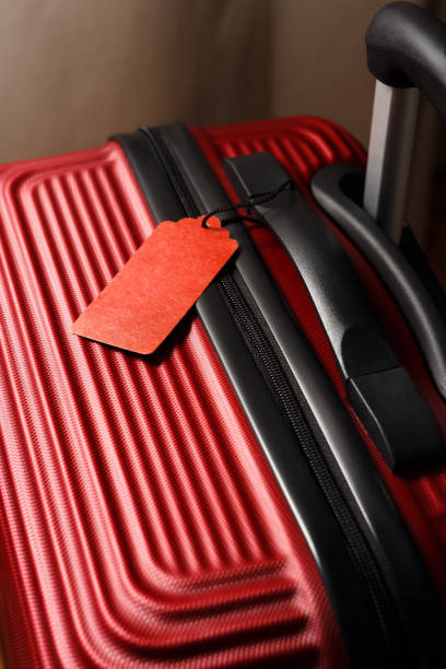 istock Red suitcase with empty travel insurance label. 1223258776