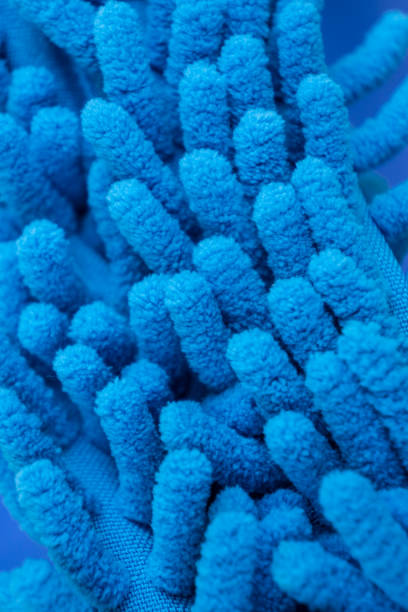 istock Macro close up of blue chenille microfiber texture for cleaning and trapping dust. Micro fiber duster closeup with fibers textures - soft machine washable material. Reusable synthetic fabric - cleans. 1223259158