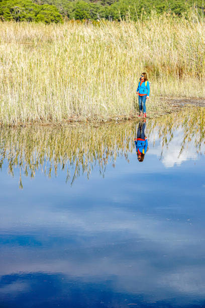 istock Woman walking by the lake. 1223259395