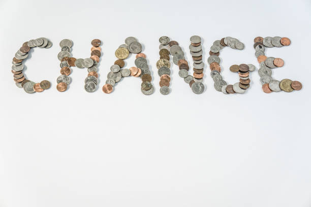 istock Coins isolated on solid white background spelling the word Change from loose coin change. Blank empty room space for text or copy. Financial mockup concept on flat lay backdrop with unique lettering. 1223260460