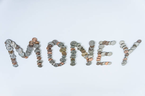 istock Coins isolated on solid white background spelling the word Money from loose coin change. Blank empty room space for text or copy. Financial mockup concept on flat lay backdrop with unique lettering. 1223260461
