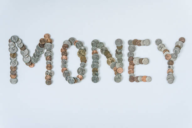istock Coins isolated on solid white background spelling the word Money from loose coin change. Blank empty room space for text or copy. Financial mockup concept on flat lay backdrop with unique lettering. 1223260462