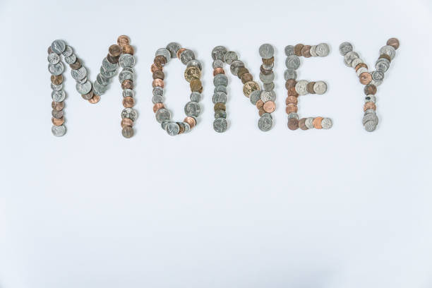 istock Coins isolated on solid white background spelling the word Money from loose coin change. Blank empty room space for text or copy. Financial mockup concept on flat lay backdrop with unique lettering. 1223260463