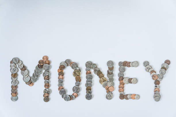 istock Coins isolated on solid white background spelling the word Money from loose coin change. Blank empty room space for text or copy. Financial mockup concept on flat lay backdrop with unique lettering. 1223260471
