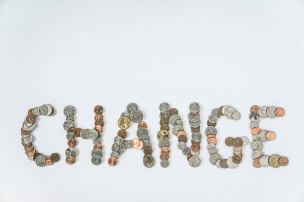istock Coins isolated on solid white background spelling the word Change from loose coin change. Blank empty room space for text or copy. Financial mockup concept on flat lay backdrop with unique lettering. 1223260477