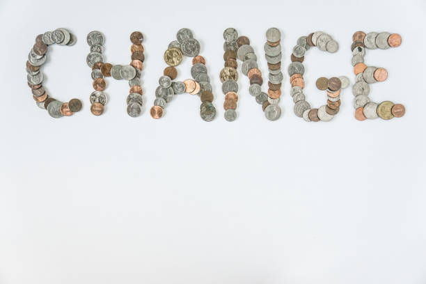 Coins isolated on solid white background spelling the word Change from loose coin change. Blank empty room space for text or copy. Financial mockup concept on flat lay backdrop with unique lettering.
