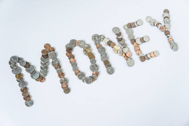 istock Coins isolated on solid white background spelling the word Money from loose coin change. Blank empty room space for text or copy. Financial mockup concept on flat lay backdrop with unique lettering. 1223260492