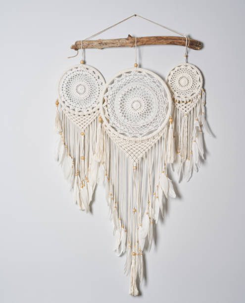 istock Three beautiful white dream catcher on the light color wall. Boho handmade style decor. 1223261776