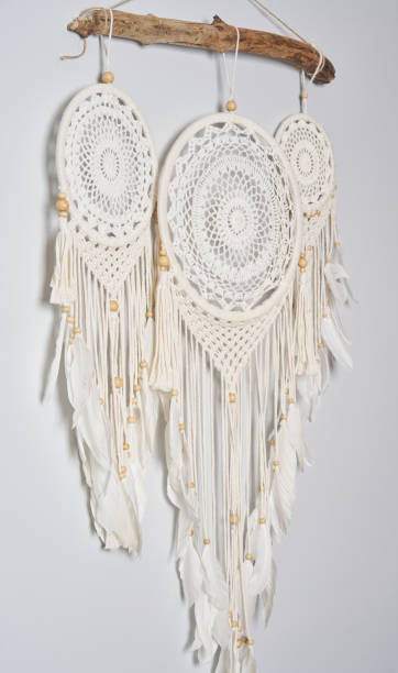 istock Three beautiful white dream catcher on the light color wall. Boho handmade style decor. 1223262135