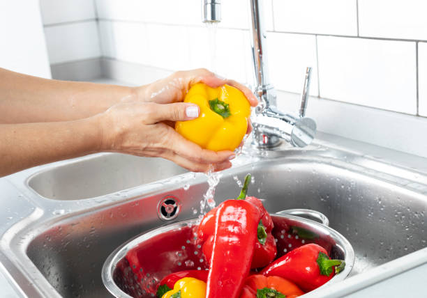 istock Peppers Being Washed in a Kitchen Sink 1223266382