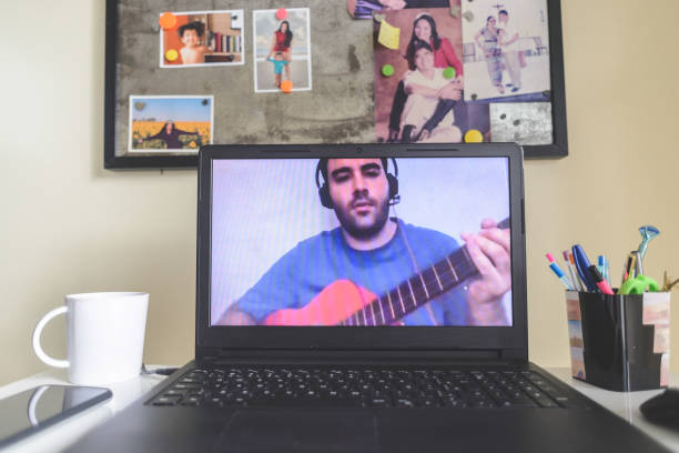istock Laptop at home displaying a virtual guitar lesson on the screen 1223268002