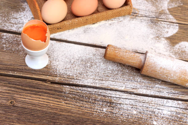 istock Background with flour and eggs on a wooden table 1223268155
