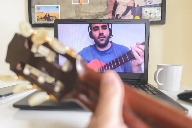 istock Playing music together, teaching or learning guitar online 1223268304