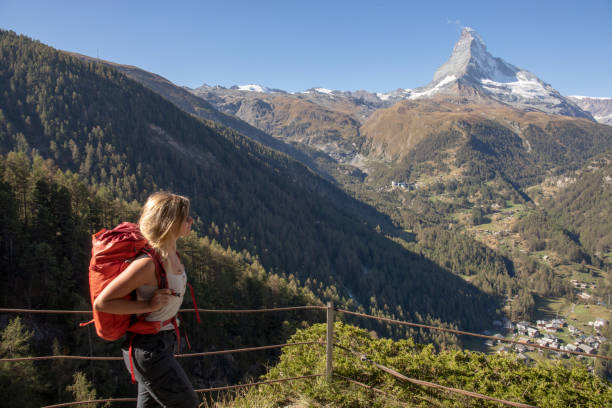 istock Young woman hikes along footpath 1223270900