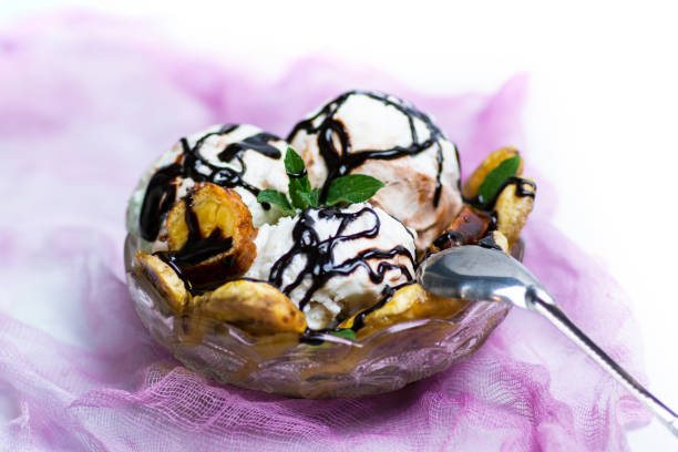 Fried banana with ice cream and cream dessert on a plate