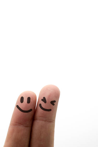 istock Painted happy finger smileys faces on hand isolated on white background.Concept and idea 1223272489