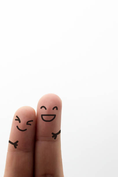 Painted happy finger smileys faces on hand isolated on white background.Concept and idea
