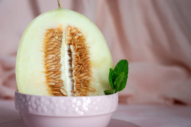 istock Fresh assortment melon with mint  on pink background 1223274030