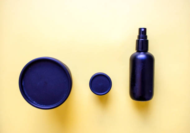 istock black plastic containers made from recycled plastic and reused for cosmetics on yellow background. Concept of recycling and eco-friendly use. Free copy space. Top view 1223275260