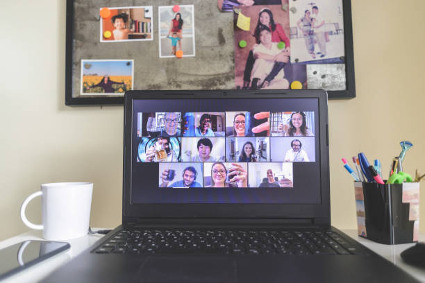 istock Virtual happy hour with many people on screen toasting online together 1223276559