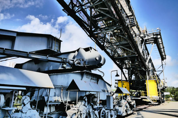 Steel giant excavator machine with conveyor bridge used in brown coal opencast mining in Germany.