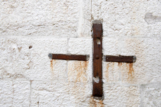 Metal cross on wall, Venice, Italy