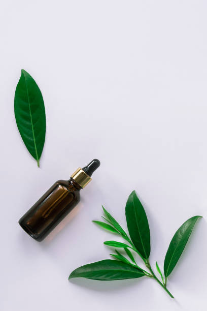 istock Cosmetic oil or serum in a bottle, top view on light grey background 1223280234