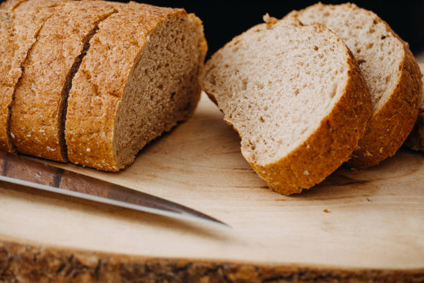 istock sliced whole wheat bread with knife on wooden drops 1223280965