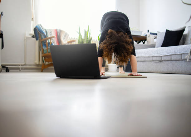 istock Young woman practicing yoga at home 1223282184