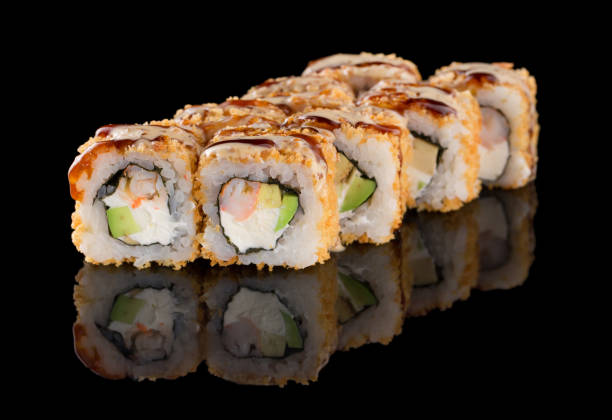 istock Sushi roll with shrimp, avocado, cheese, omelet breading isolated on black background with reflection 1223282917