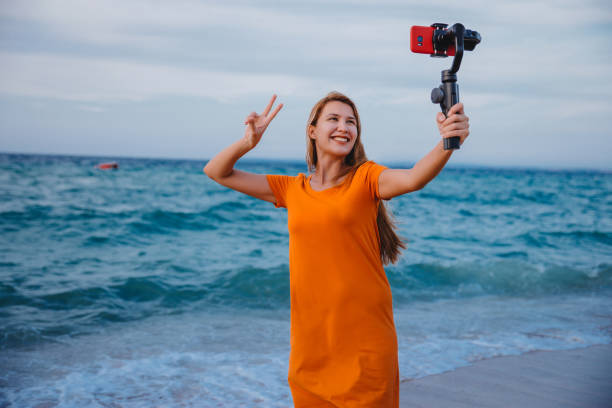 istock Woman record vlog video on beach 1223283203