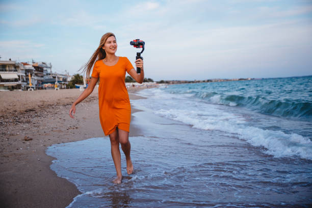 istock Woman record vlog video on beach 1223283216
