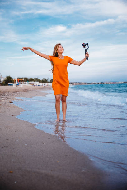 Woman record vlog video on beach