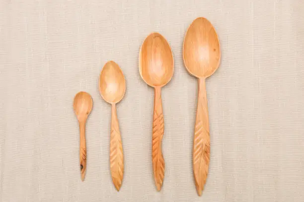 Houseware: wooden kitchen utensils, isolated on grey cotton background top view. Zero waste, eco friendly concept. Flat lay.