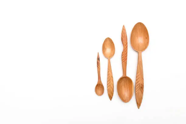 Houseware: wooden kitchen spoons, isolated on white background top view. Zero waste, eco friendly concept. Flat lay.