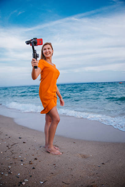 istock Woman vlogging from beach 1223283820