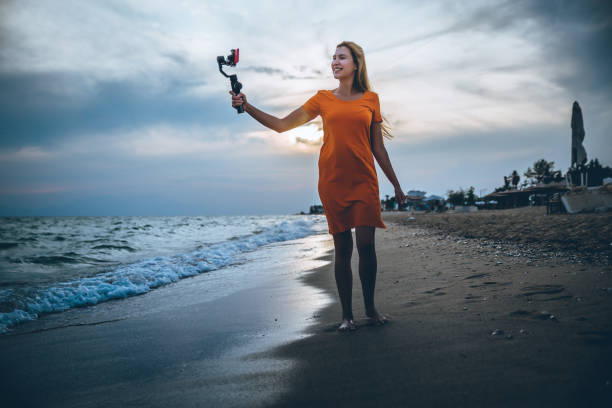 istock Woman vlogging from the seaside at sunset 1223284028