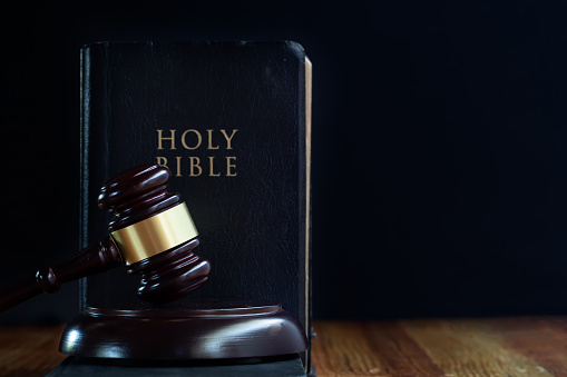 Judge's gavel and holy bible book on wooden table