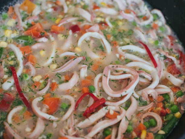 istock Squid rings with vegetables stewed in a frying pan 1223286448