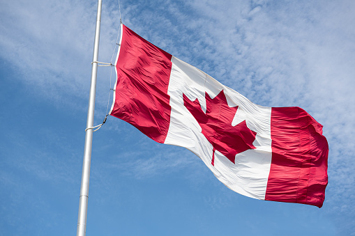 Canadian Flag Flies in front of an heritage Building in Montreal