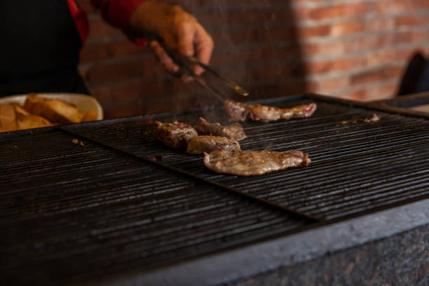 istock chef cooking meat on the grill 1223292601