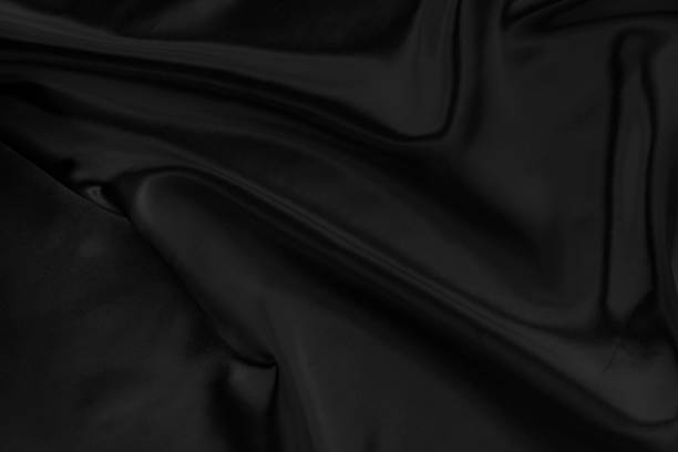 istock Black gray satin dark fabric texture luxurious shiny that is abstract silk cloth background with patterns soft waves blur beautiful. 1223293558