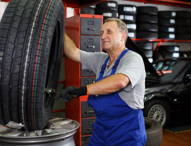istock Mechanic repairing car wheel 1223294521